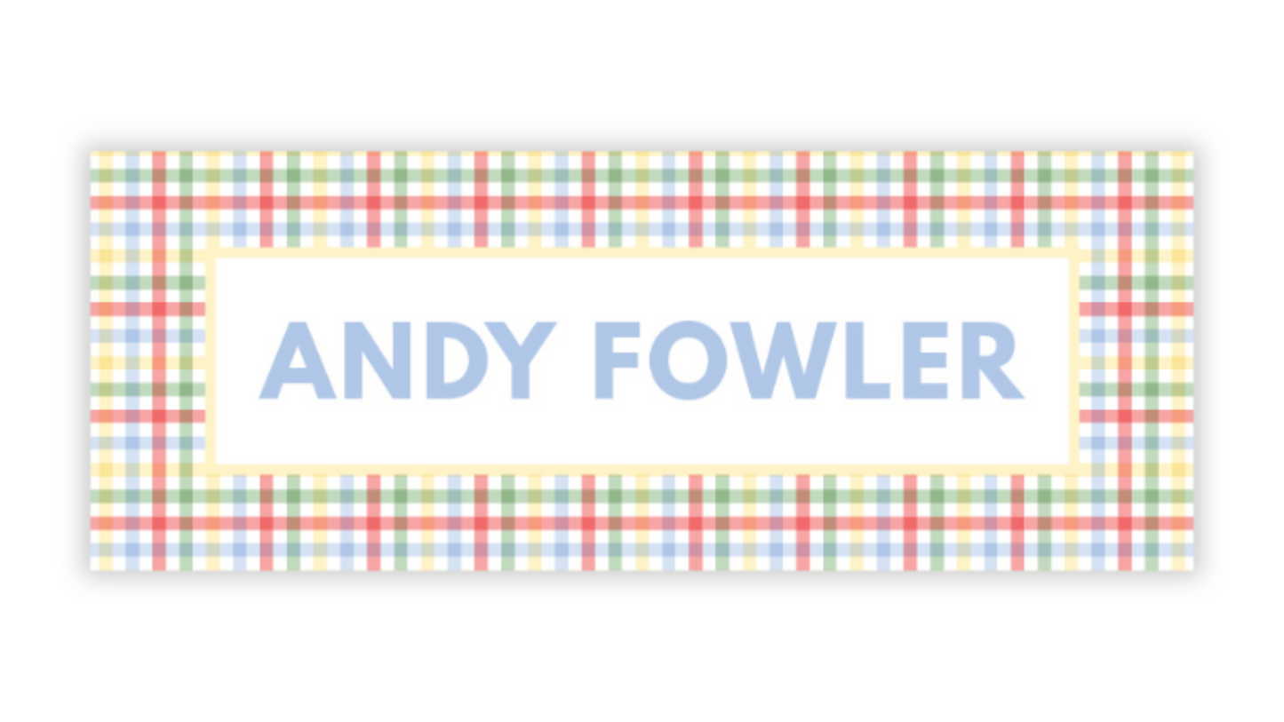 a rectangular sign with a checkered pattern and the name "ANDY FOWLER" written in blue text.