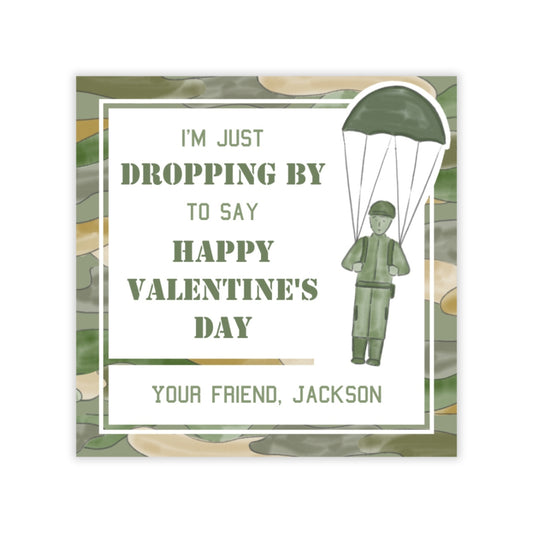 The image is a Valentine's Day card with a camouflage pattern and a parachutist illustration. The text on the card reads: "I'm just dropping by to say happy valentine's day your friend, jackson".