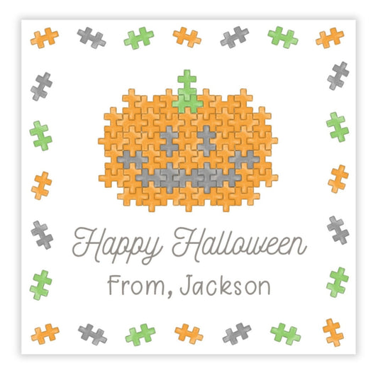 A personalized Halloween gift tag featuring a puzzle block design with a pumpkin in the center, and the text 'Happy Halloween from Jackson'.