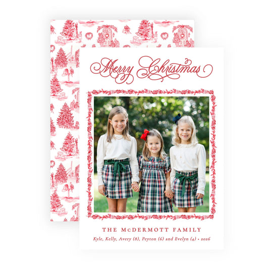 A personalized Christmas family card and matching envelope set. The white card features red script text reading 'Merry Christmas' and 'The McDermott Family' with a central photo of three young girls in plaid skirts, framed by a red floral border.