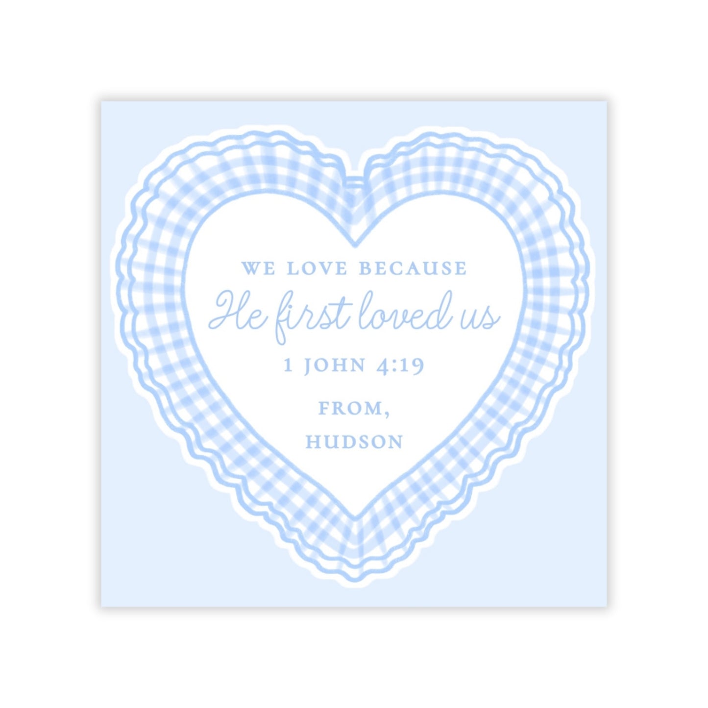 The image is a heart-shaped graphic with a blue and white checkered pattern around it. Inside the heart, there is text that reads "We love because He first loved us 1 John 4:19 FROM, HUDSON".