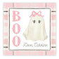 A personalized gift tag with a 'BOO' text and a cartoon ghost illustration in a pink checkered background, with the name 'Caroline' printed at the bottom.
