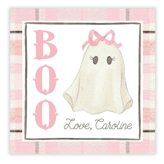 A personalized gift tag with a 'BOO' text and a cartoon ghost illustration in a pink checkered background, with the name 'Caroline' printed at the bottom.