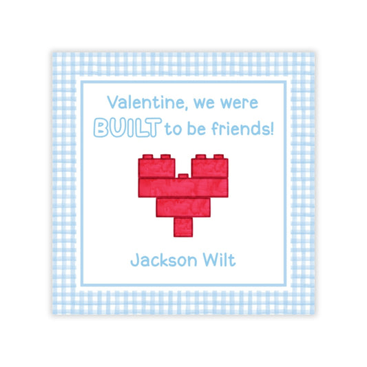 The image is a Valentine's Day card with a heart-shaped LEGO brick design and a message about being friends.
