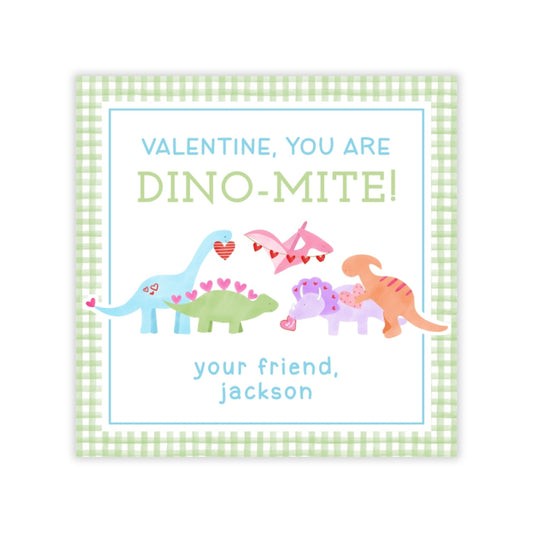 The image is a Valentine's Day card featuring a dinosaur theme. The card has a green and white checkered border and displays a message that reads "Valentine, you are DINO-MITE!" along with illustrations of various dinosaur characters. The card also includes a message that reads "your friend, jackson" at the bottom.