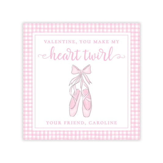 The image is a Valentine's Day card with a pink and white checkered border. The card features a pair of ballet shoes with a bow on them, and the text "Valentine, you make my heart twirl" is written above the shoes.
