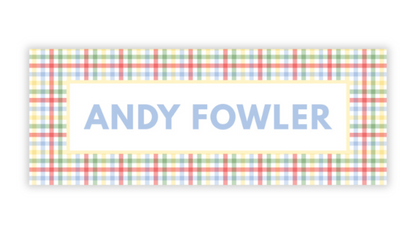 a rectangular sign with a checkered pattern and the name "ANDY FOWLER" written in blue text.