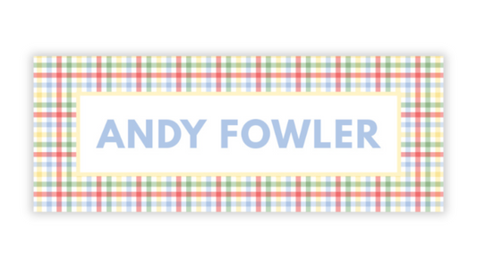 a rectangular sign with a checkered pattern and the name "ANDY FOWLER" written in blue text.