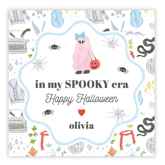 A personalized Halloween gift tag with a cartoon pumpkin character, spider, and cobwebs in a circular design with the text 'In my Spooky Era Happy Halloween' and a name 'Olivia'.